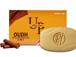 "Ultra Pure OUDH Scrub Soap with golden packaging on marble surface, showing exfoliating granules and rich texture. Luxury skincare product for glowing skin with exotic Arabian OUDH fragrance."